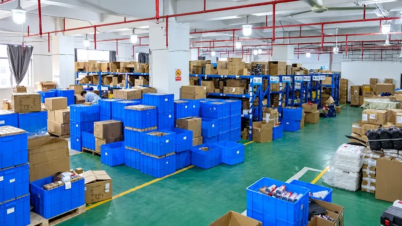Packed cartons and finished goods staged for shipping in a solar lighting factory warehouse